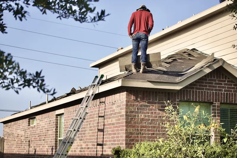 Professional roofer working on a residential roof in Cummings